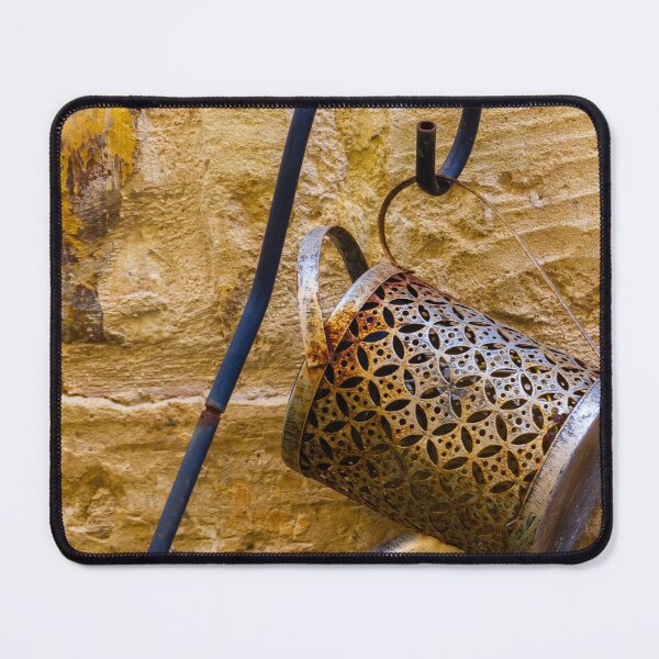 Item preview, Rusty Decorative Watering Can Hanging On Textured Yellow Stone Wall With Vintage Charm designed and sold by Nmallia.