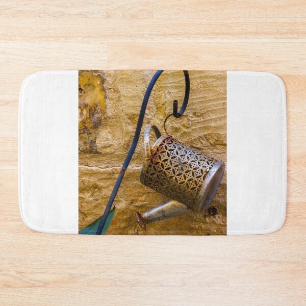 Item preview, Rusty Decorative Watering Can Hanging On Textured Yellow Stone Wall With Vintage Charm designed and sold by Nmallia.