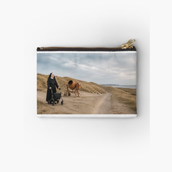 Item preview, A nun in coastal dunes with a rollator beside an old concrete mixer designed and sold by Per-Madsen.
