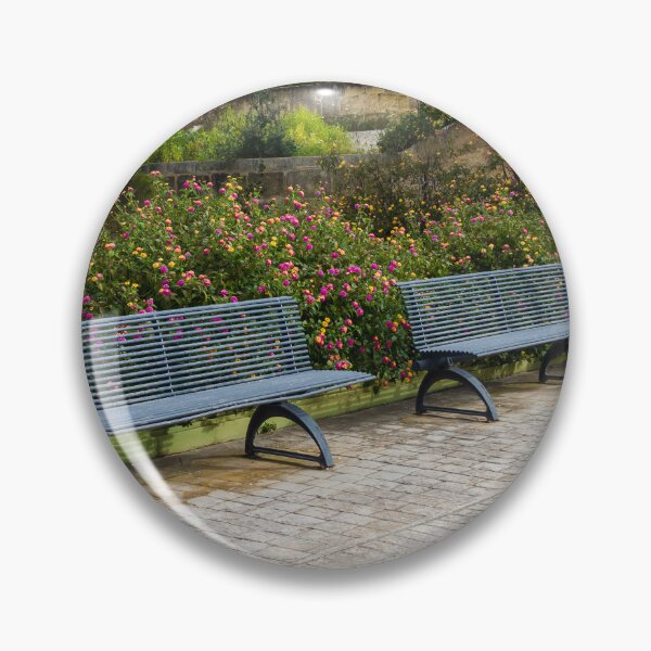 Item preview, Empty Metal Benches in Flower Garden Next to Stone Wall in Outdoor Park designed and sold by Nmallia.