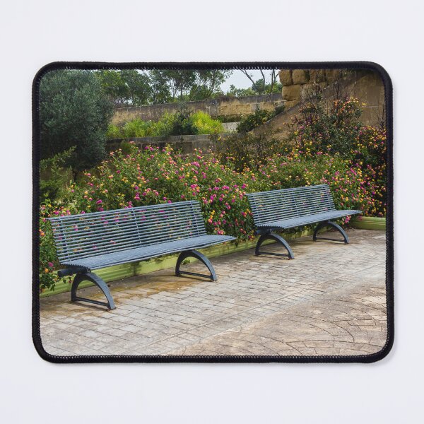 Item preview, Empty Metal Benches in Flower Garden Next to Stone Wall in Outdoor Park designed and sold by Nmallia.