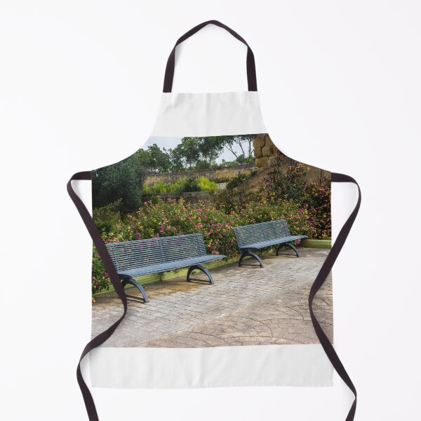 Item preview, Empty Metal Benches in Flower Garden Next to Stone Wall in Outdoor Park designed and sold by Nmallia.