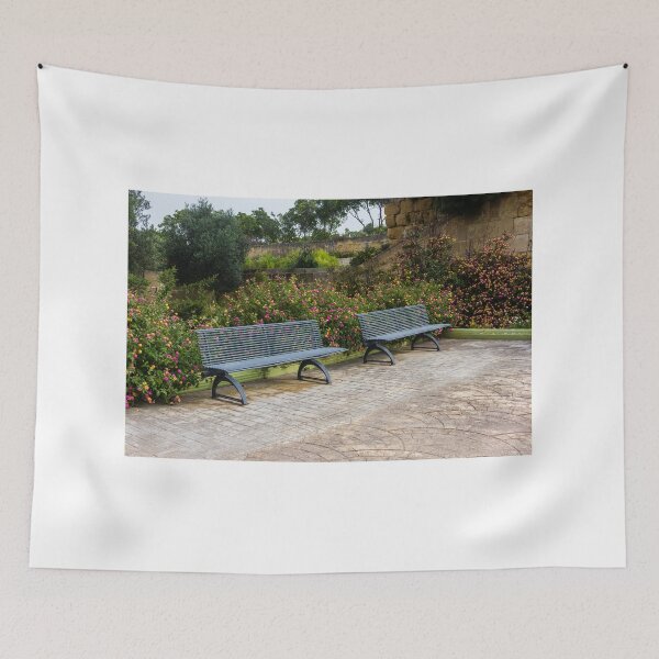 Item preview, Empty Metal Benches in Flower Garden Next to Stone Wall in Outdoor Park designed and sold by Nmallia.