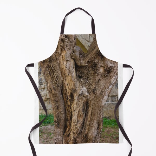 Item preview, Old Gnarled Tree Trunk With Weathered Bark Texture Against Stone Wall In Garden Setting designed and sold by Nmallia.