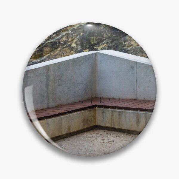 Item preview, Concrete Corner Bench With Wooden Slats Against Weathered Rock Wall In Outdoor Park designed and sold by Nmallia.