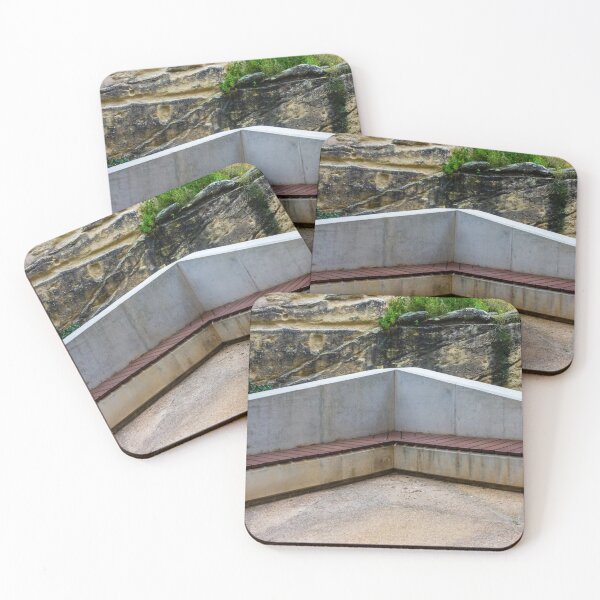 Item preview, Concrete Corner Bench With Wooden Slats Against Weathered Rock Wall In Outdoor Park designed and sold by Nmallia.