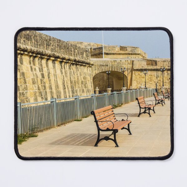 Item preview, Row Of Wooden Benches Along Historic Stone Fort Promenade On Sunny Empty Walkway designed and sold by Nmallia.