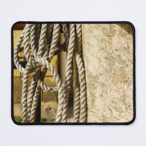 Item preview, Coiled Rope Hanging on Stone Railing Beside Marble Wall with Sunlit Texture and Shadows designed and sold by Nmallia.