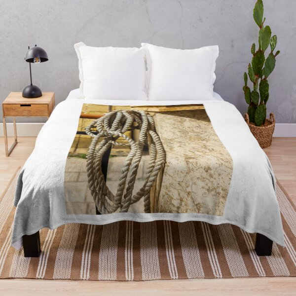 Item preview, Coiled Rope Hanging on Stone Railing Beside Marble Wall with Sunlit Texture and Shadows designed and sold by Nmallia.