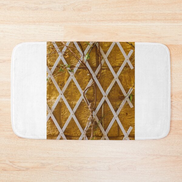 Item preview, Climbing Vine on White Trellis Against Textured Yellow Brick Wall Rustic Garden Background designed and sold by Nmallia.
