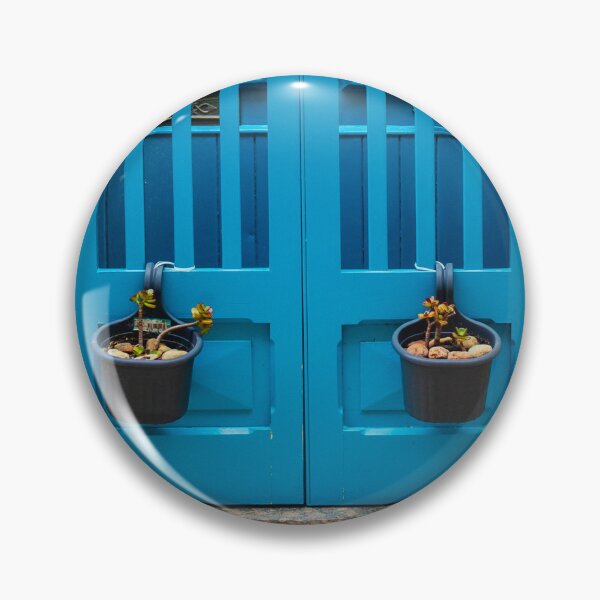 Item preview, Bright Blue Door With Hanging Plant Pots Against Sunlit Yellow Stone Wall In Mediterranean Street designed and sold by Nmallia.