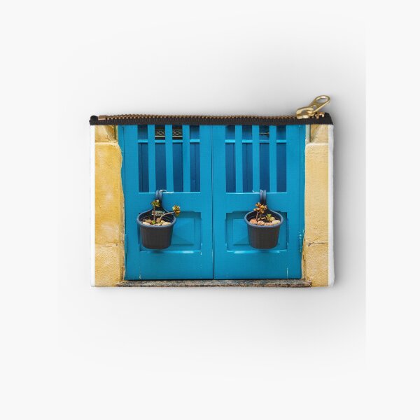 Item preview, Bright Blue Door With Hanging Plant Pots Against Sunlit Yellow Stone Wall In Mediterranean Street designed and sold by Nmallia.