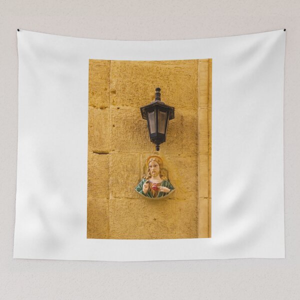Item preview, Jesus Sacred Heart Statue Beside Vintage Wall Lamp On Stone Church Wall In Warm Light designed and sold by Nmallia.