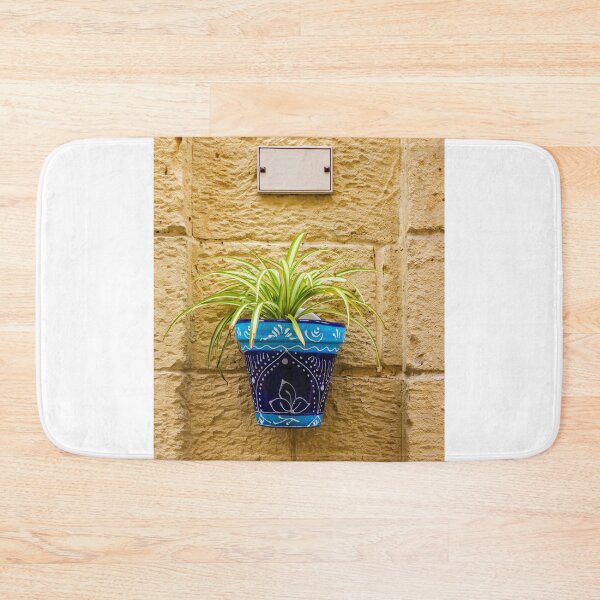 Item preview, Blue Ceramic Pot With Green Potted Plant Hanging On Textured Stone Wall In Sunny Outdoor Decor designed and sold by Nmallia.