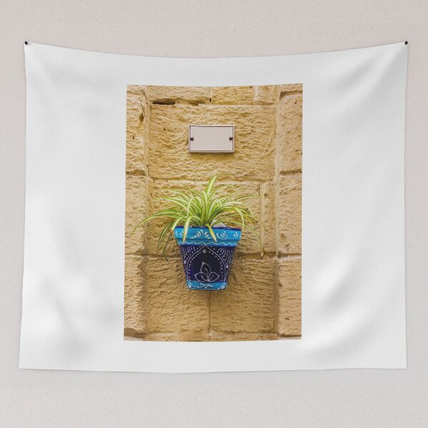 Item preview, Blue Ceramic Pot With Green Potted Plant Hanging On Textured Stone Wall In Sunny Outdoor Decor designed and sold by Nmallia.