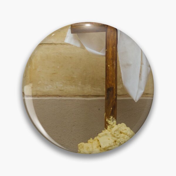 Item preview, Wooden Cross Draped With White Cloth Standing on Yellow Foam Pile Against Stone Wall designed and sold by Nmallia.