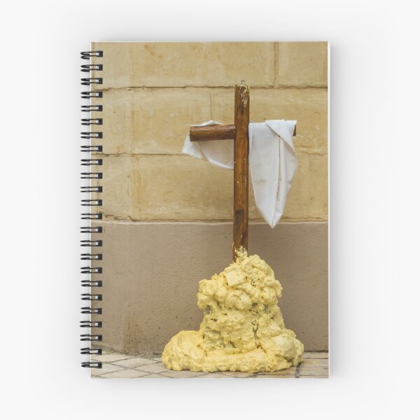 Item preview, Wooden Cross Draped With White Cloth Standing on Yellow Foam Pile Against Stone Wall designed and sold by Nmallia.