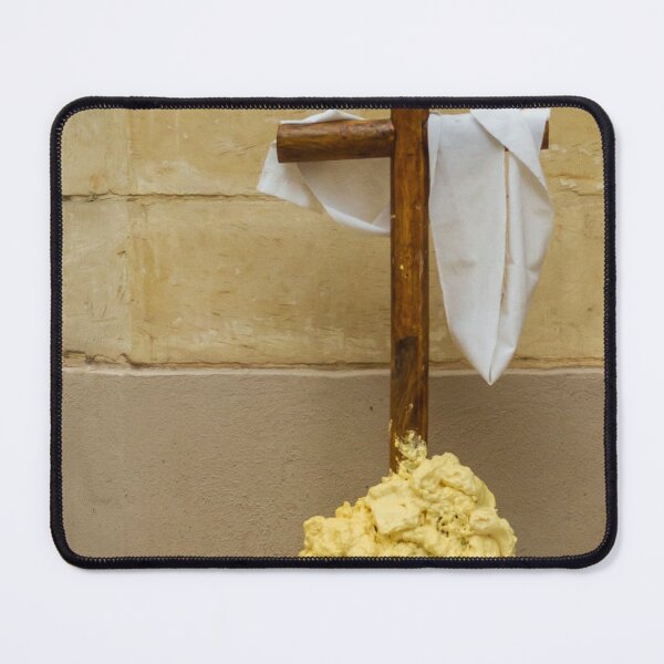 Item preview, Wooden Cross Draped With White Cloth Standing on Yellow Foam Pile Against Stone Wall designed and sold by Nmallia.