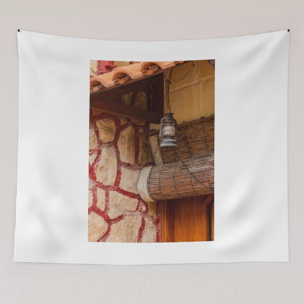 Item preview, Rustic Lantern Hanging Beside Stone Wall and Terracotta Roof Over Wooden Door in Vintage Exterior designed and sold by Nmallia.