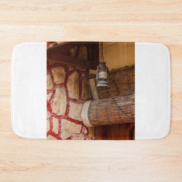Item preview, Rustic Lantern Hanging Beside Stone Wall and Terracotta Roof Over Wooden Door in Vintage Exterior designed and sold by Nmallia.