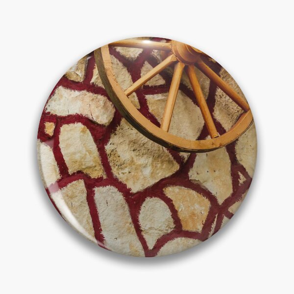 Item preview, Rustic Wagon Wheel Mounted on Textured Stone Wall With Red Grout Accent for Exterior Decor designed and sold by Nmallia.