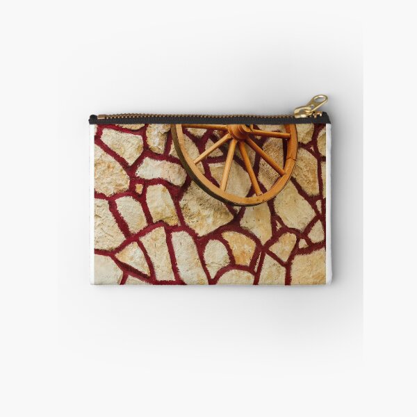 Item preview, Rustic Wagon Wheel Mounted on Textured Stone Wall With Red Grout Accent for Exterior Decor designed and sold by Nmallia.