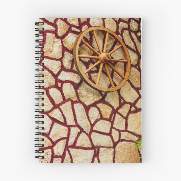 Item preview, Rustic Wagon Wheel Mounted on Textured Stone Wall With Red Grout Accent for Exterior Decor designed and sold by Nmallia.