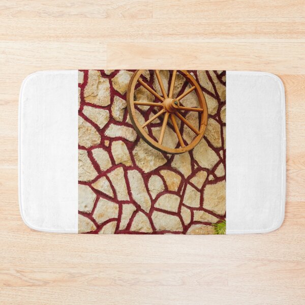 Item preview, Rustic Wagon Wheel Mounted on Textured Stone Wall With Red Grout Accent for Exterior Decor designed and sold by Nmallia.