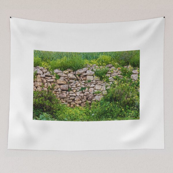 Item preview, Old Dry Stone Wall Covered With Green Vines And Wildflowers In Lush Meadow designed and sold by Nmallia.