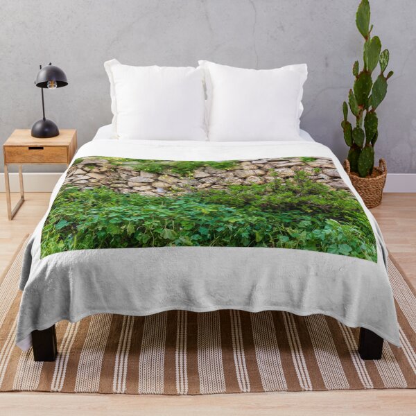 Item preview, Old Dry Stone Wall Covered With Green Vines And Wildflowers In Lush Meadow designed and sold by Nmallia.