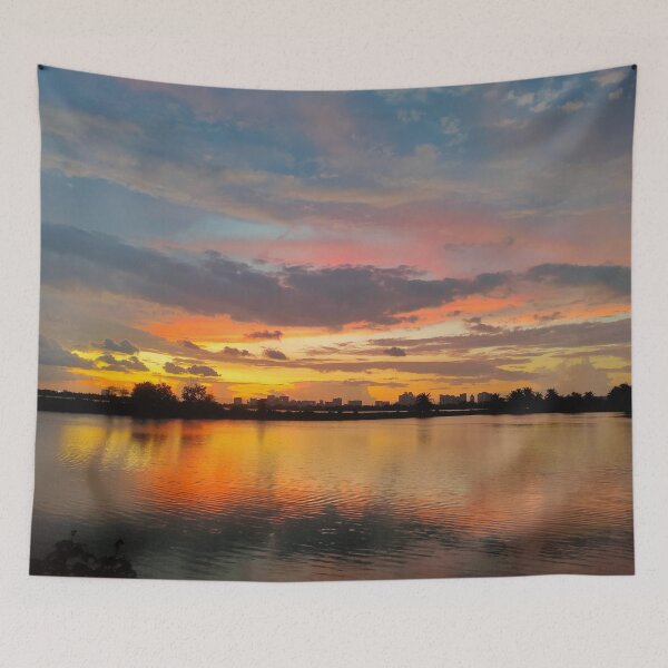Item preview, Shillhoute of trees and water body under Orange sky at evening  designed and sold by MagicMaker1984.