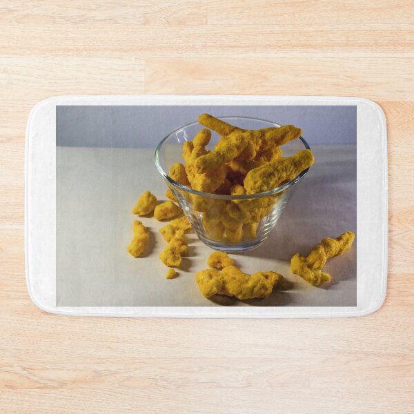 Item preview, Cheesy Corn Puffs Snack In Glass Bowl With Scattered Pieces On White Background designed and sold by Nmallia.
