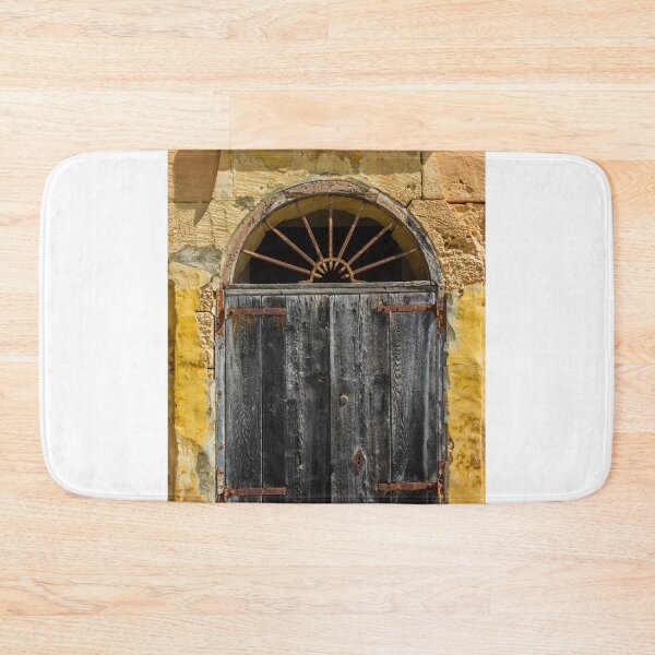 Item preview, Weathered Wooden Door In Arched Yellow Stone Facade With Rusted Hinges And Vintage Charm designed and sold by Nmallia.