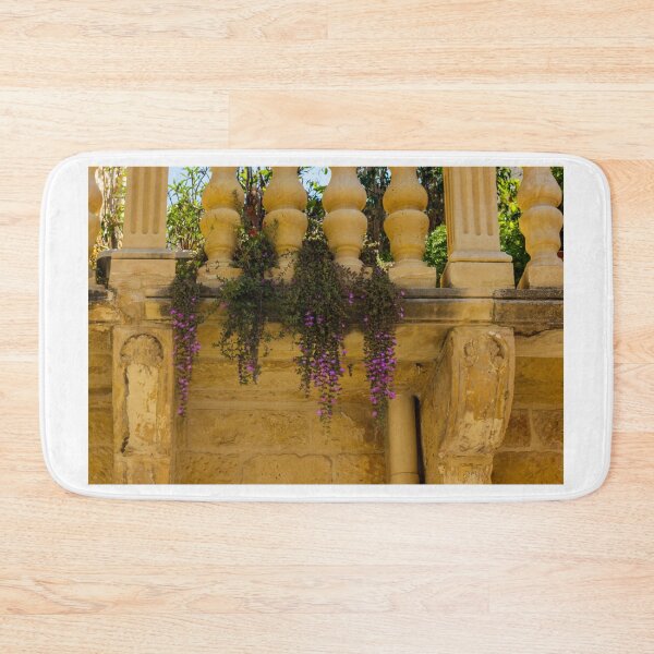Item preview, Rustic Stone Balcony With Purple Hanging Flowers and Ornate Balustrade in Warm Sunlight designed and sold by Nmallia.