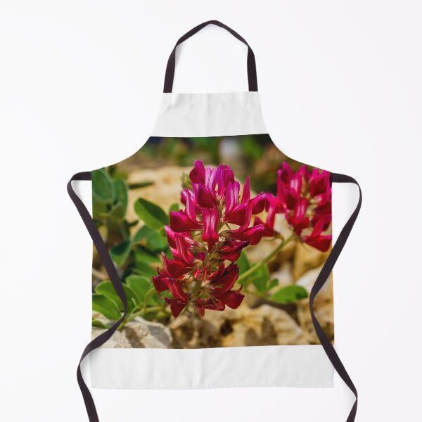 Item preview, Red Wildflower Blooming Among Rocks With Green Leaves In A Sunny Natural Setting designed and sold by Nmallia.