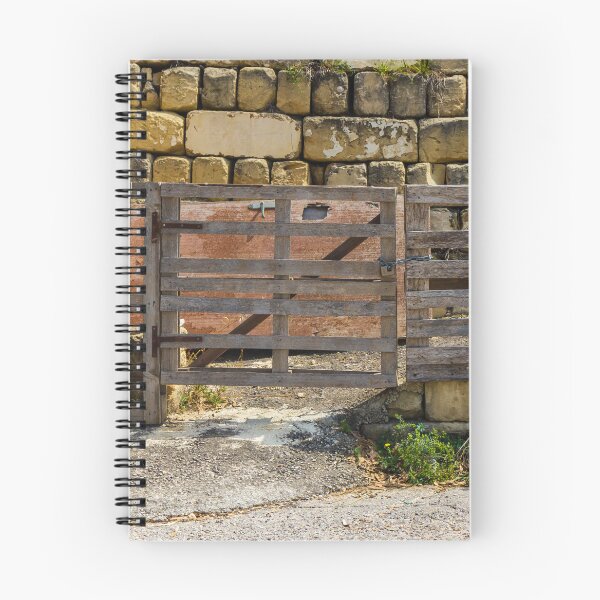 Item preview, Rustic Wooden Gate and Pallet Fence Against Weathered Stone Wall in Rural Farmyard Entrance designed and sold by Nmallia.