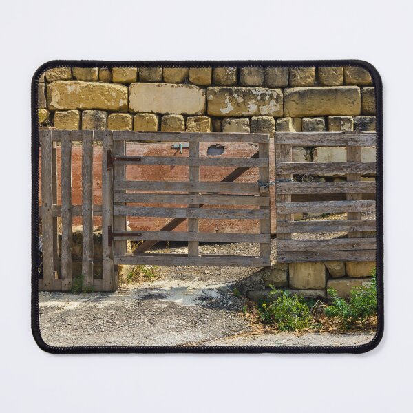 Item preview, Rustic Wooden Gate and Pallet Fence Against Weathered Stone Wall in Rural Farmyard Entrance designed and sold by Nmallia.