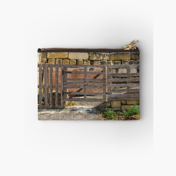 Item preview, Rustic Wooden Gate and Pallet Fence Against Weathered Stone Wall in Rural Farmyard Entrance designed and sold by Nmallia.