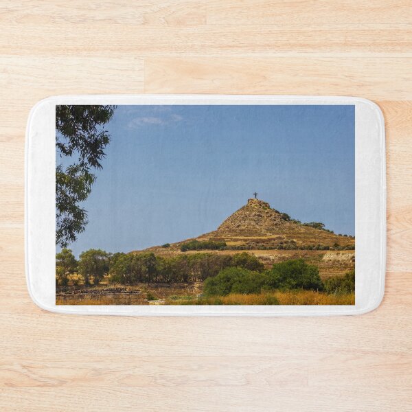 Item preview, Hilltop Cross On Rocky Mound Overlooking Rural Landscape Under Clear Blue Sky designed and sold by Nmallia.