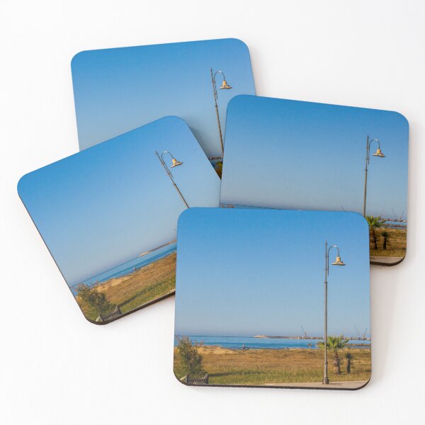 Item preview, Coastal Promenade Lamp Post Overlooking Calm Sea, Sandy Dunes and Distant Harbor Cranes at Sunrise designed and sold by Nmallia.