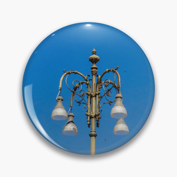 Item preview, Ornate Vintage Street Lamp Against Bright Blue Sky With Elegant Metalwork and Hanging Lights designed and sold by Nmallia.