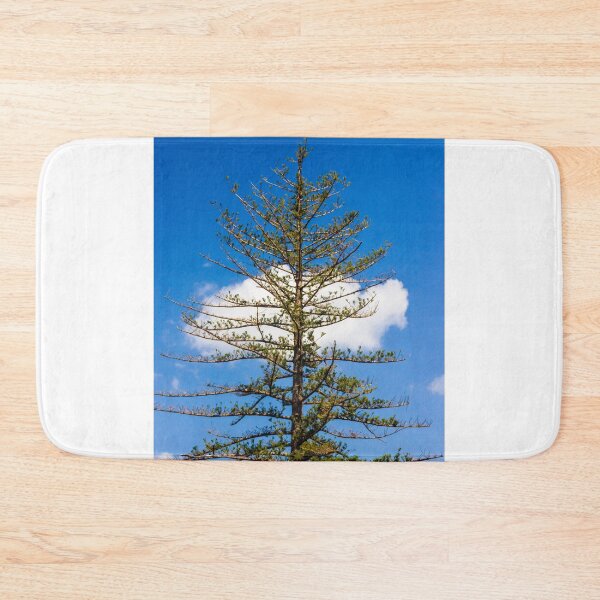 Item preview, Tall Pine Tree Against Bright Blue Sky With White Cloud and Sparse Branches in Nature designed and sold by Nmallia.