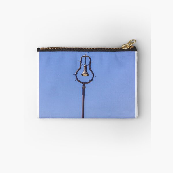Item preview, Vintage Ornamental Bell Street Lamp Against Clear Blue Sky With Green Foliage designed and sold by Nmallia.