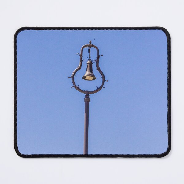 Item preview, Vintage Ornamental Bell Street Lamp Against Clear Blue Sky With Green Foliage designed and sold by Nmallia.
