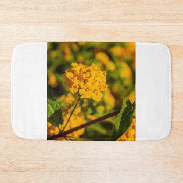 Item preview, Yellow Lantana Flower Cluster Close-Up With Green Leaves And Soft Bokeh Background designed and sold by Nmallia.
