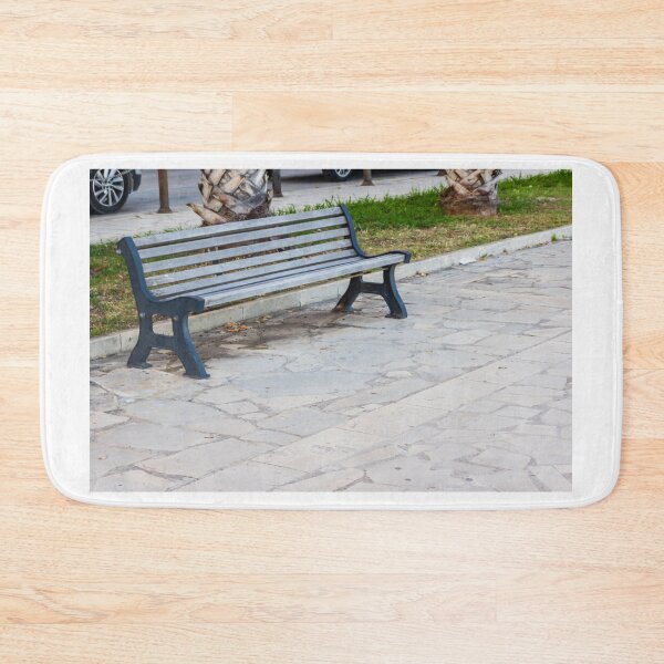 Item preview, Empty Park Bench on Stone Pavement Near Palm Trees in Urban Outdoor Public Space designed and sold by Nmallia.