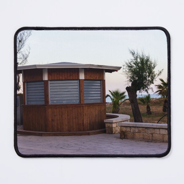 Item preview, Closed Wooden Beach Kiosk on Seafront Promenade With Palm Trees and Calm Evening Sky designed and sold by Nmallia.