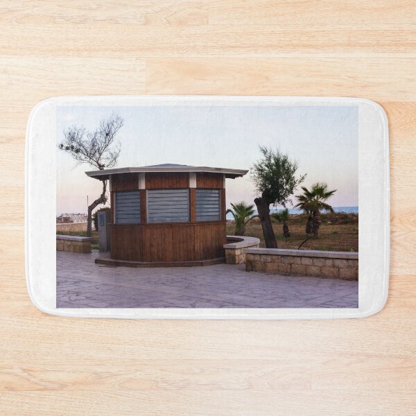 Item preview, Closed Wooden Beach Kiosk on Seafront Promenade With Palm Trees and Calm Evening Sky designed and sold by Nmallia.