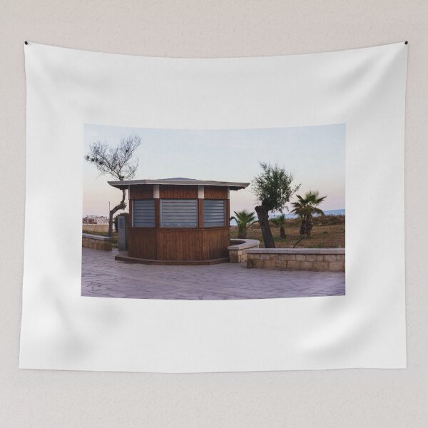 Item preview, Closed Wooden Beach Kiosk on Seafront Promenade With Palm Trees and Calm Evening Sky designed and sold by Nmallia.