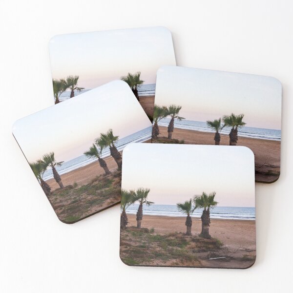 Item preview, Tranquil Beach With Palm Trees Along Sandy Shoreline at Pastel Sunrise Over Calm Sea designed and sold by Nmallia.